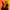 Inter-Alia-Rosamund-Pike-National-Theatre-2000x2000 A person with shoulder-length hair poses in a dynamic stance against an orange background. They wear a black blazer with gold embroidery over a white shirt. One arm is raised, and the other has a fabric band with text.